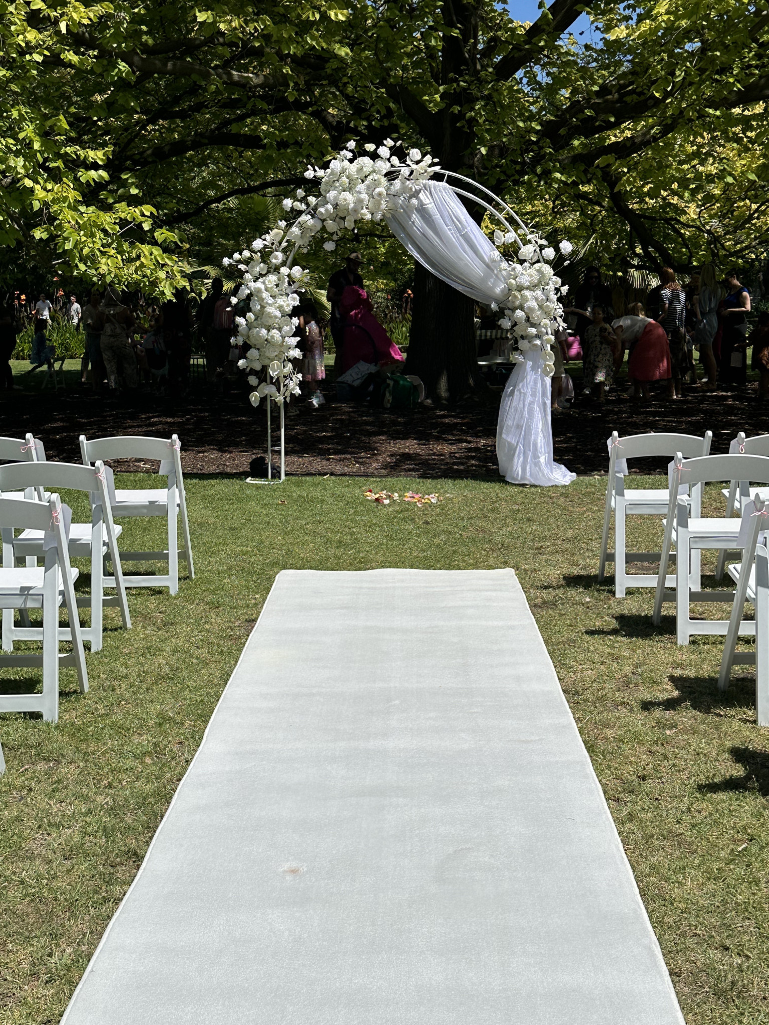 Wedding Ceremony Floral Arch, White Carpet Runner, Americana Chairs